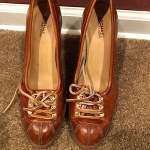 Michael Korrs brown leather shoes.